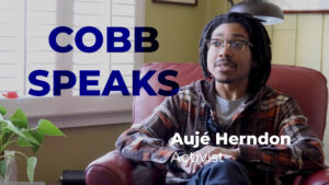 A screenshot of a youtube video featuring a young man in a flannel shirt