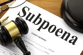 A photo showing a subpoena and gavel